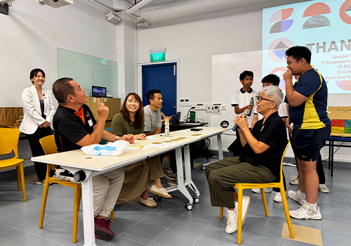 A Hougang Secondary student presented to a panel and received feedback during a co-design session.