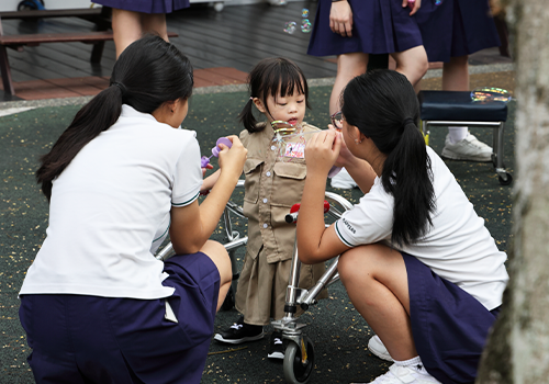 Raffles Girls’ School students playing with children during the Inclusive Play Lab.